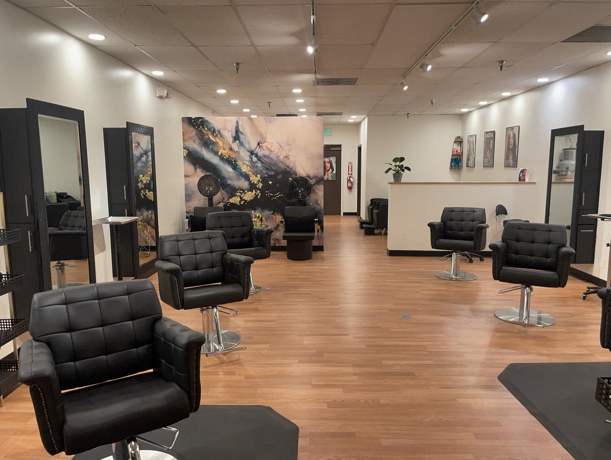 Fully image of salon that featured Vivian Ferne Peel and stick wallpaper featuring stunning navy, teal and black ink tones. Gold leafing created stunning depth and shine on this custom wallpaper mural.