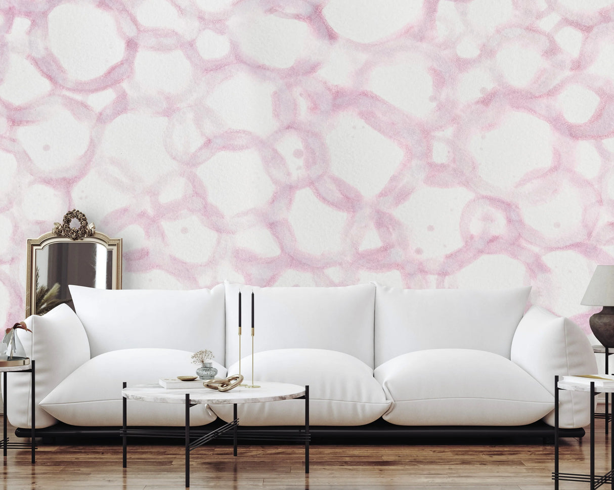 This living room interior design staging ultra modern, minimal coffee tables and floor level puffy white couch. The walls are decorated with a pink themed, large pattern wallpaper. This wall decor can be achieved using prepasted, peel and stick or French Luxe wallpaper.