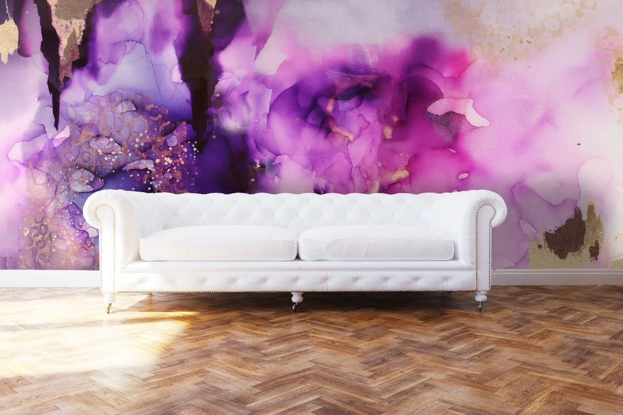 This luxury living room interior design look was completed using a stunning Chesterfield tufted sofa, herringbone hardwood floors and a large scale abstract wallpaper installation. The wallpaper design includes golds, lilacs, plums and other rich purple tones created from an original abstract painting by artist, Fran Maass. This interior wallpaper design is perfect for anyone seeking bold, adventurous decor options.