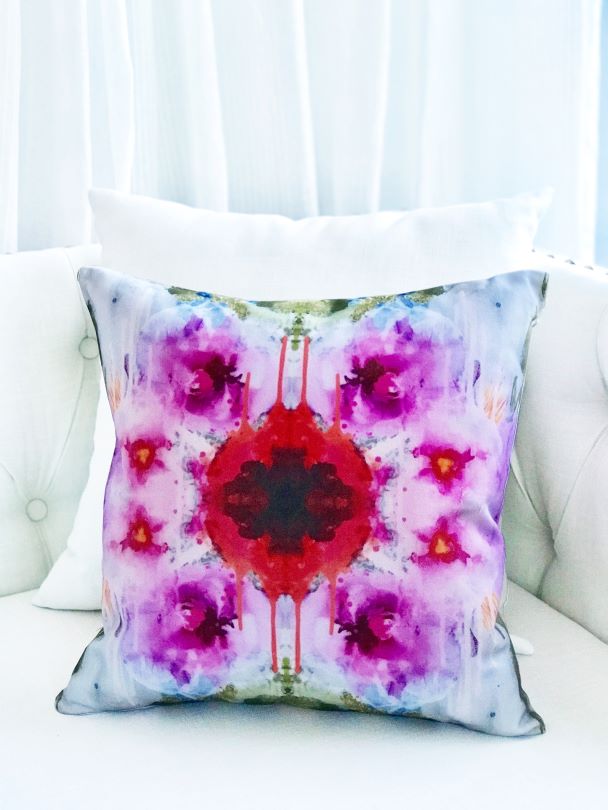 Abstract designer flower pillow on a classic white couch