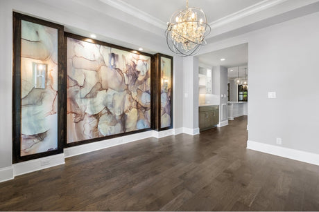 Chic luxury dining room with classic bronze chandelier and abstract wallpaper mural with recessed framing.