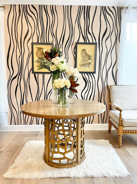 Explore this unique wallpaper pattern featuring curved lines and brushstrokes. This black and beige large pattern design makes a stunning feature wall for hotel lobbies, salon walls, spa entrance decor and residential living room spaces. The design is available in prepasted, french luxe and peel&stick materials. Custom wallpaper sizes are available.