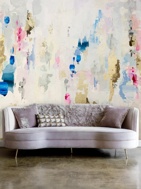 This beached themed interior design installation features, marine blues, peaches and beiges on the wallpaper and a concrete polished floor design. The couch in this staging is a  Chesterfield style.