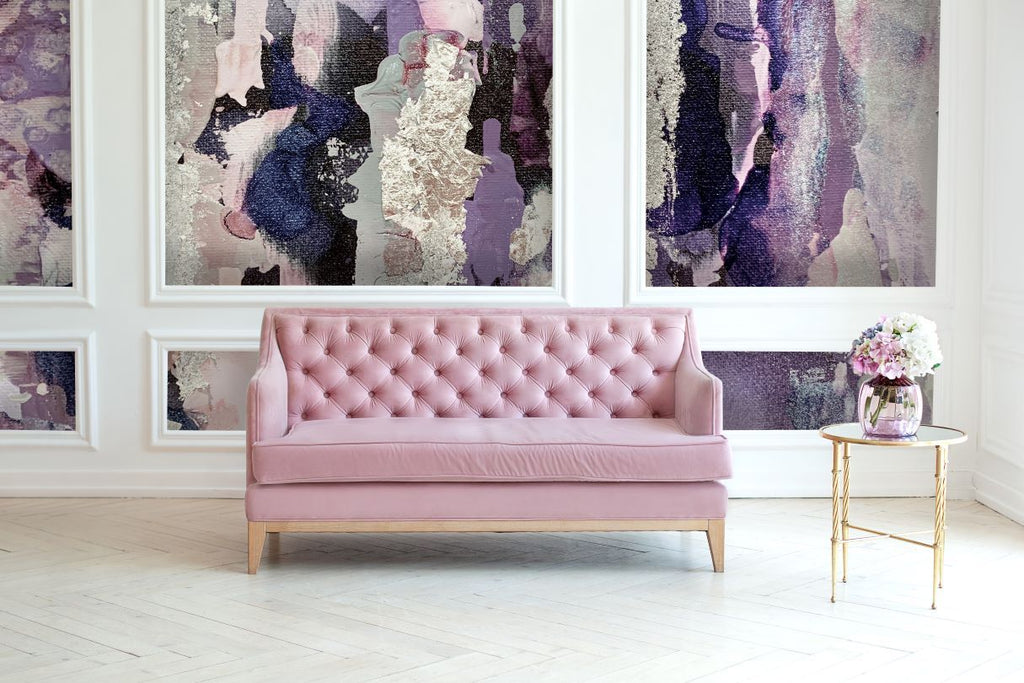 Staged photo of a luxury living room with large scale abstract wallpaper design. Unique wall decor will transform any space into an interior design masterpiece. The "Lavender" wallpaper is available in prepasted and peel and stick materials.