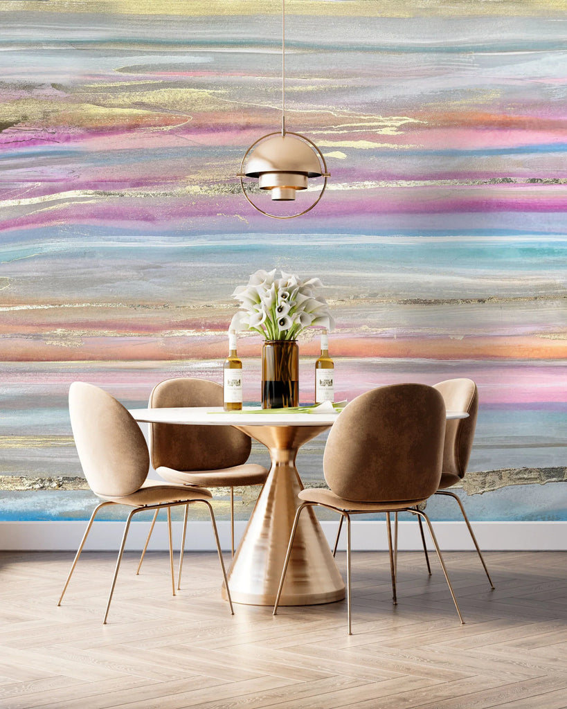 The colorful blue, purple and gold wallpaper design featured in a dining room modern interior decor theme. The look features suede chairs, minimal copper and stone table, glass vase and tulips. The design showcases how horizontal lines can make a space feel wider. The wallpaper is available in prepasted and peel and stick. 