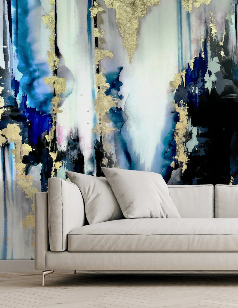 Close up of living room interior design with modern furniture and large abstract wall decor. This design features inky blues, grays and gold tones. This modern abstract wall decor is a moody stunning installation that will turn any living room interior design project into a work of art. 