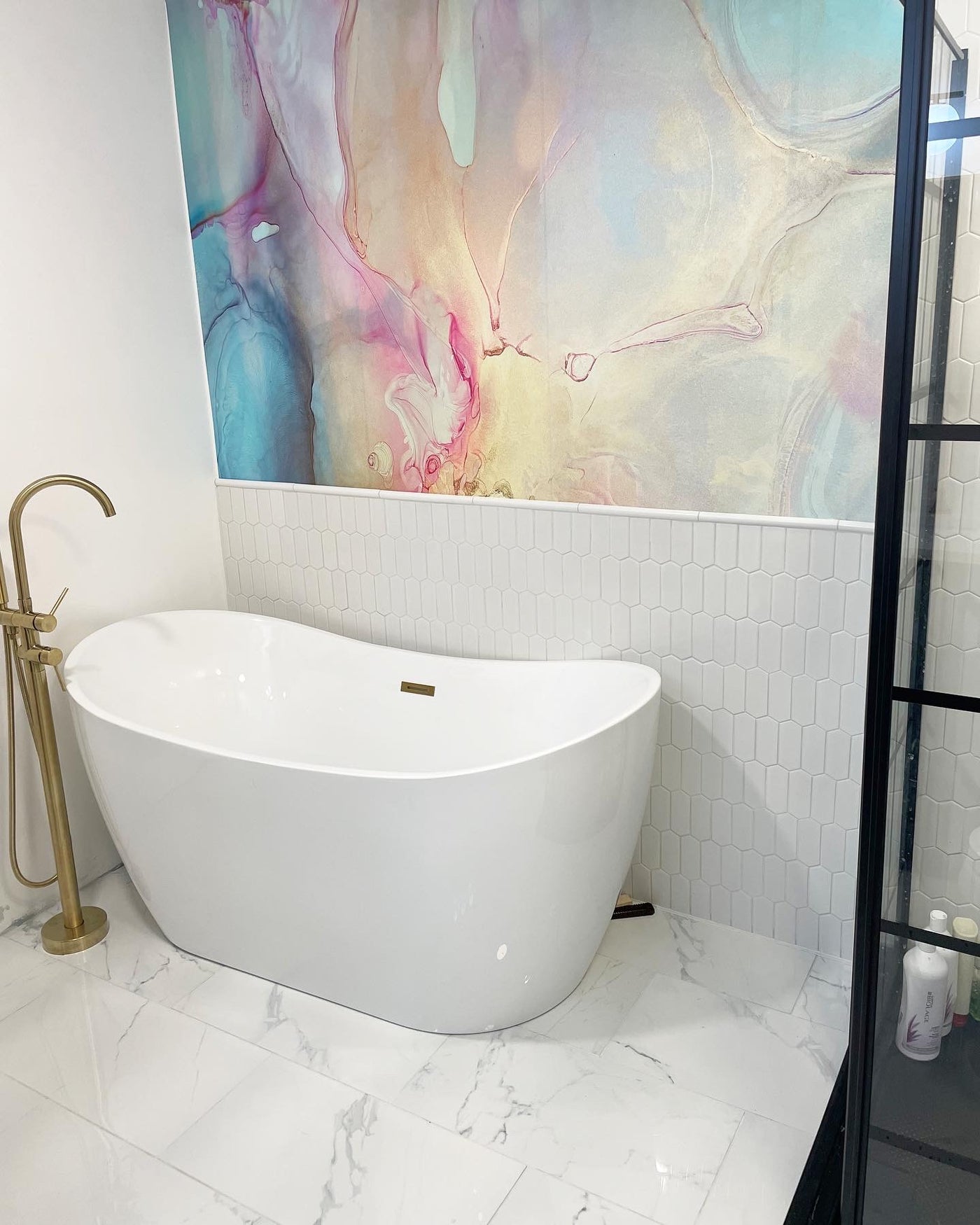 Modern bathroom with a freestanding bathtub, gold faucet, and colorful "Bubble" Wall Mural wall paper from Vivian Ferne.