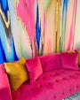 Colorful abstract wallpaper design featured with fuchsia luxury sofa. The abstract wallpaper design is a great addition for spa decor, hotel decor, office decor and any other bold luxury interior design space.