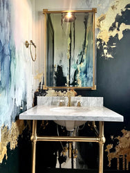 This classic brass and stone bathroom sink and luxury wallpaper design from Vivian Ferne create the ultimate modern classic bathroom. The large scale wallpaper mural adds edgy modern mood against the classic fixtures of the bathroom.