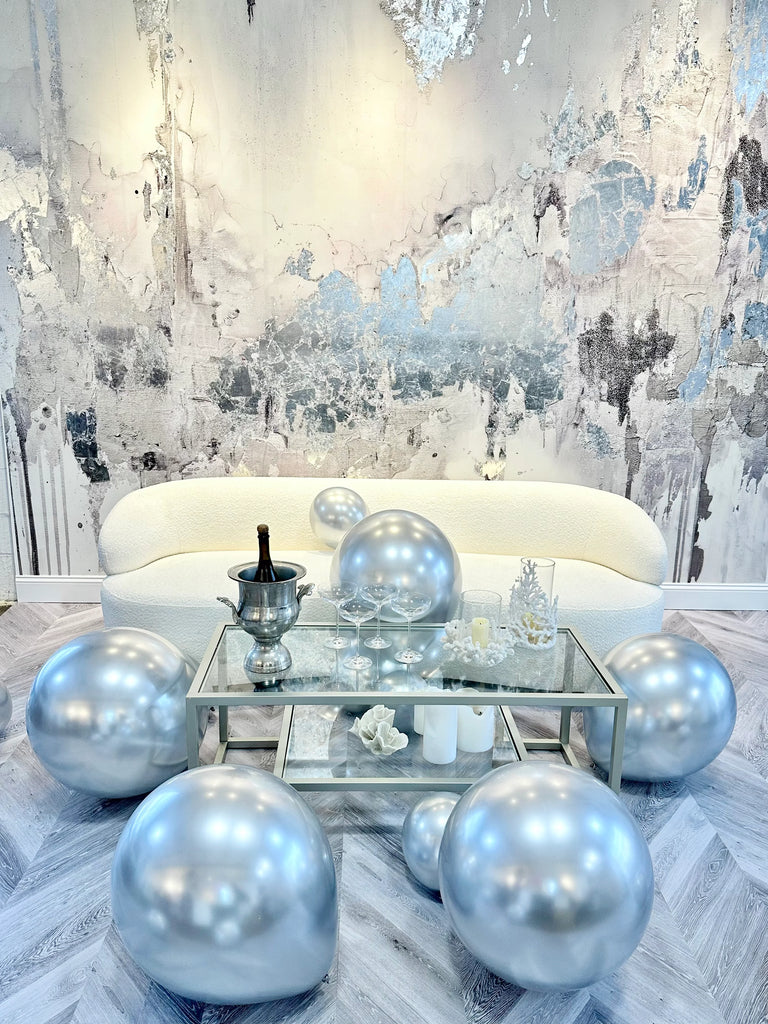 This monochromatic interior wall decor features electric silver tones, silver leaf textures and intricate brushstrokes. This wall mural was created by famous interior designer, Fran Maass Katz using acrylic paint, alcohol inks and silver leafing. This wall mural design is available in prepasted and peel and stick materials.