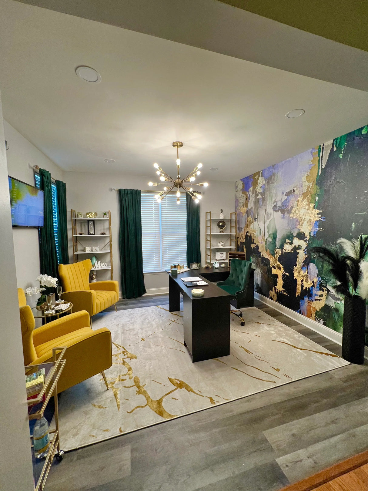 This luxury office space featuring gold and green furniture features the Huntress wallpaper that is richly colored with greens, blues and golds. The wallpaper installation was completed with our peel and stick wallpaper product.