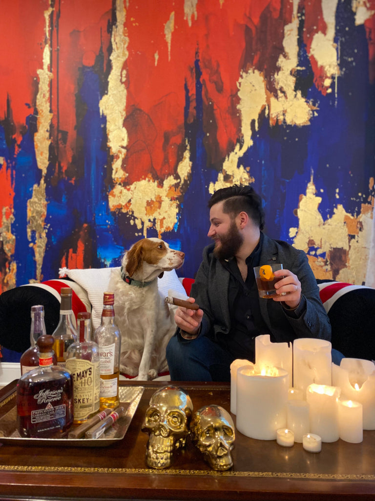 Dress your man-cave up with this luxury red, blue and gold abstract wallpaper design. These gold, red and blue tones create a beautiful array of tones and textures. This photo features candles, finished classic wood tables, fine whisky and our favorite dogs.