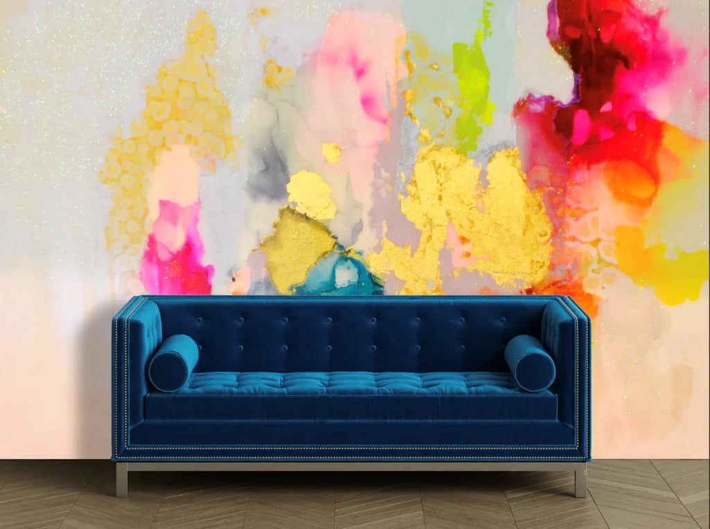 Mid-Century Modern Living room with blue velvet sofa and large abstract wall decor. The wallpaper in this living room layout consists of  nude peach, deep blue, and blooming pansy with a twist of lemon-lime. This design is edgy, modern and the perfect match for clients looking to make bold interior design choices this spring and summer.
