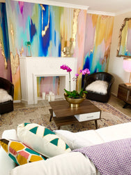 This custom living room decor was completed using rainbow themed wallpaper. The wide range of colors (mints, lilacs, blues, peaches and yellows) create an array of color that provides depth and texture to any living room space. This interior design was also inspired by white sofas and pillows, wooden coffee tables, large candle holders, and decorative fireplace settings.