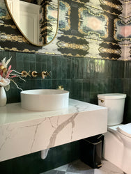 green powder room, green tile bathroom, green tile powder room, sconce in powder room, marble vanity, luxury home powder room, luxury bathroom, bathroom wallpaper