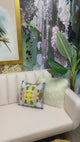 This video shows the final walk through of Vivian Ferne's staging of the tropical themed wallpaper design, Lovebird. This design was applied using peel and stick wallpaper and staged using a pink sofa, gold pillows, framed bird prints, and palm trees.