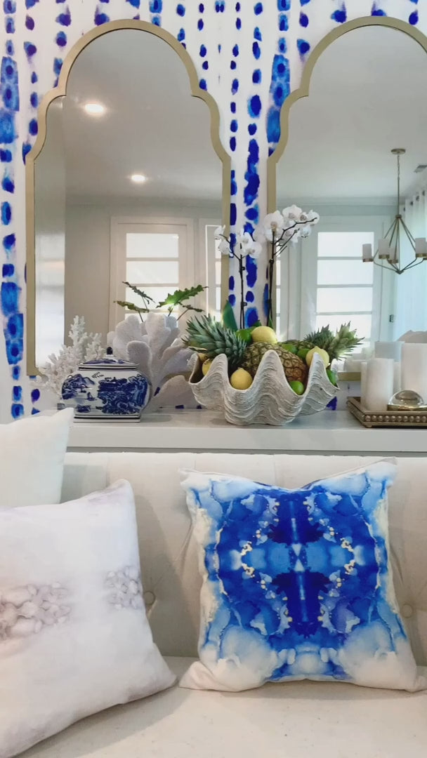 A walk through of this white and blue living room interior design project. The furniture is white and modern while the wallpaper presents a large pattern blue and white themed pattern. This living room is an ocean themed room that brings the calming textures of the Greek sea into your home.