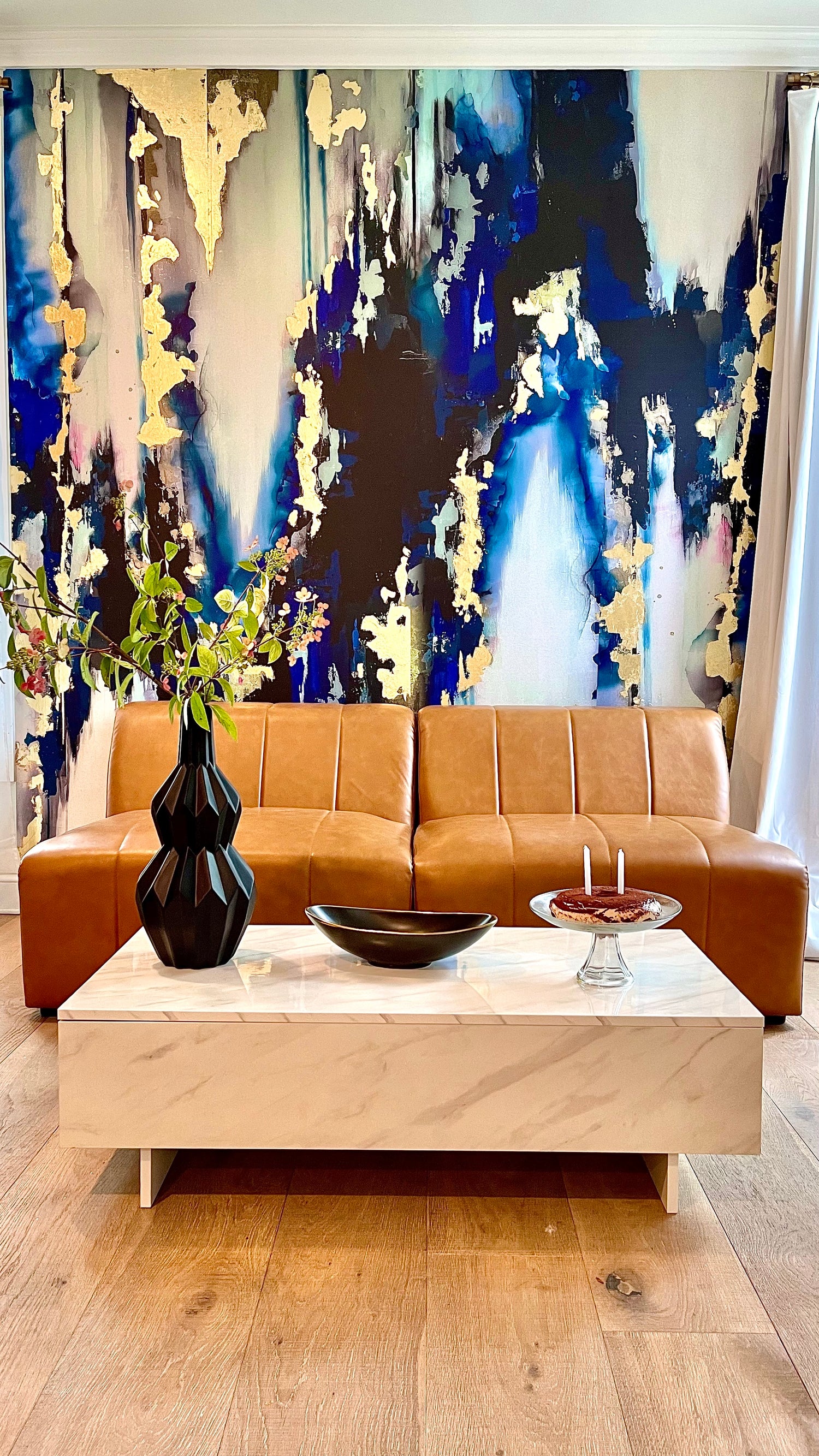 Turn your living room interior design into a master-piece with a luxury abstract wallpaper mural. The deep ink blues, navy tones grays and black create a stunning colorscape across any installation. The gold leafing adds a stunning multi-media element to this interior wall decor. 