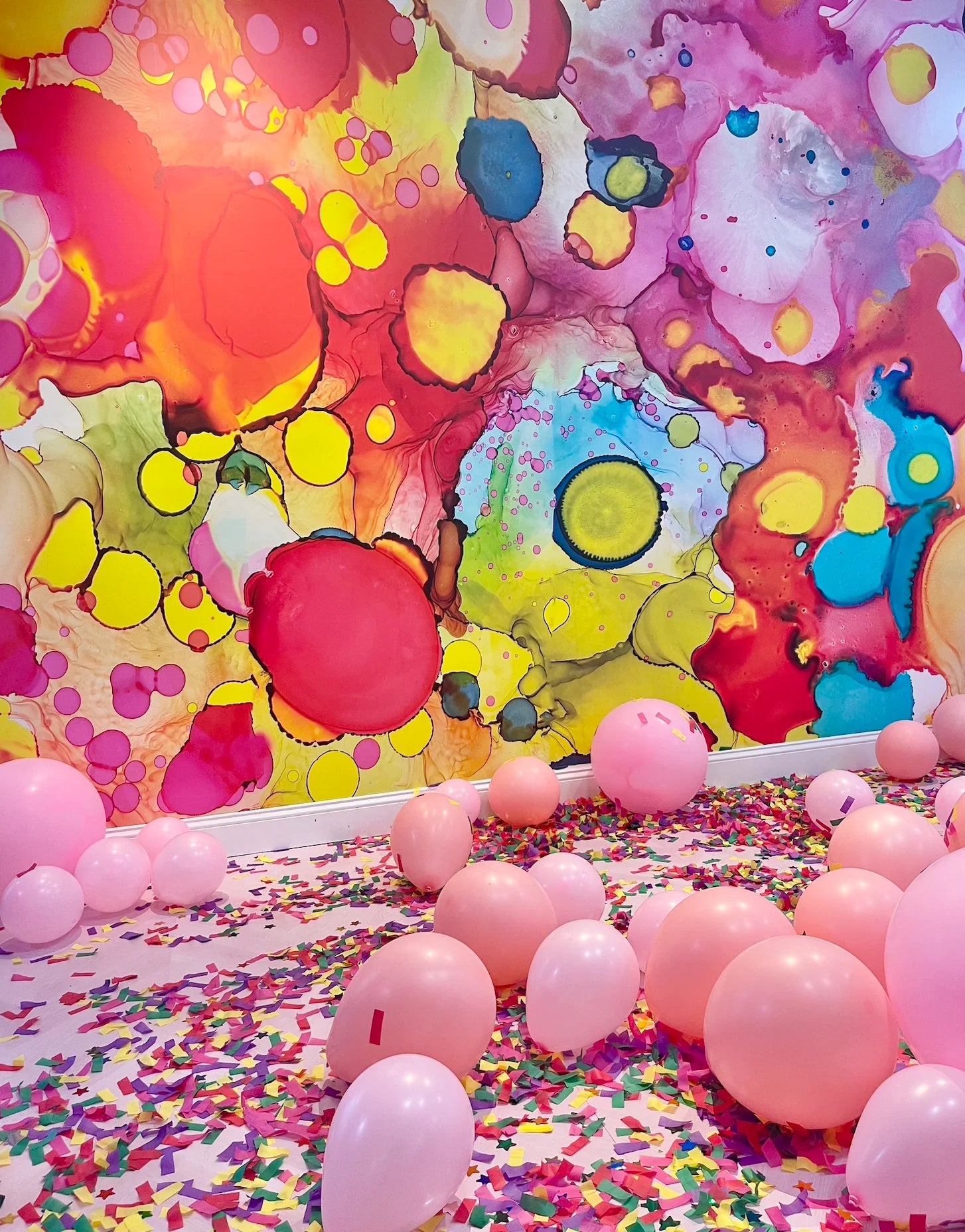 Best Abstract Interior Wall Decor - Vibrant Multi Colored Wall Art  had crafted for living room and dining room wall decor. Hi-resolution wall art from a woman owned business. The colorful circular shapes of green, red, blue and purple fill this abstract wall mural deign that is available in prepasted, peel and stick and French Luxe materials.