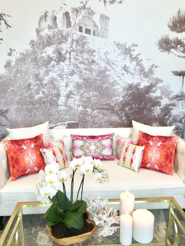 Chichén Itzá wall mural behind white couch with colorful pillows