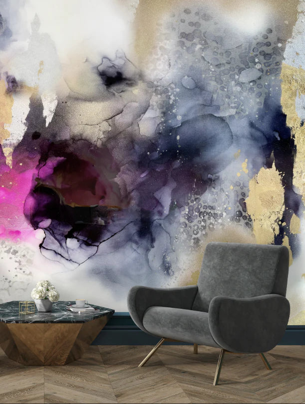 A close up look at the living room interior design concept that features a large abstract, raspberry, purple, navy and gold texture wallpaper. The soft suede chairs and herringbone flooring create a magnificent foreground to this interior design setup. 