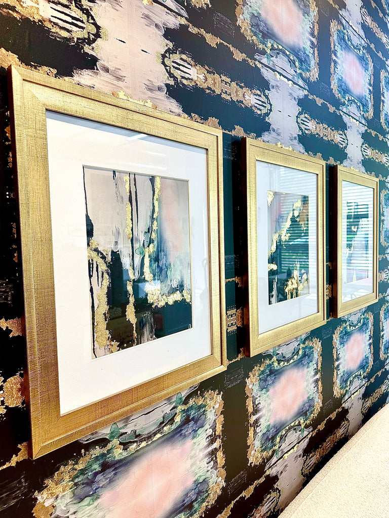Close up photo of interior living room design with gold framed prints and abstract art design. Set of three framed prints. These framed prints with gold leafing offer a stunning wall decor option for hotels, spas, medical offices airbnbs and any other luxury interior design space.