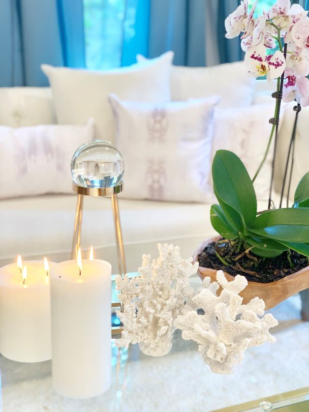 light grey and white pillow collection on a white sofa