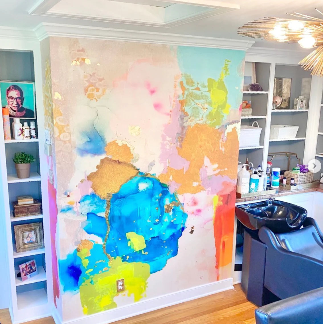 This salon used avant-garde wallpaper from famous interior designer, Vivian Ferne to create a stunning accent wall. This wall features lush, rich blues, limes, peach tones and stark brushstrokes to create a one of a kind interior decor installation.