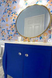 Powder Room Accent Wall with Blue Cabine and Gold Round Mirror.