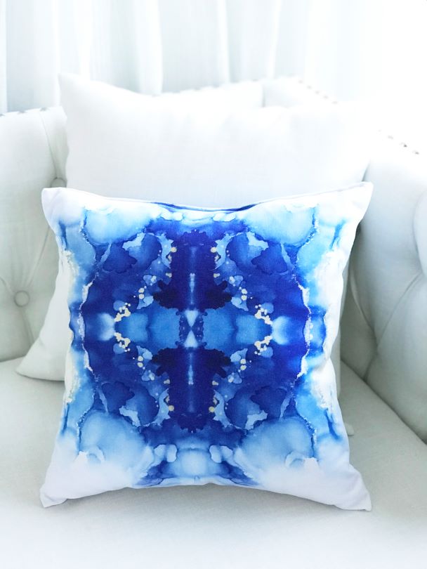 Blue designer pillow for sale on a white couch