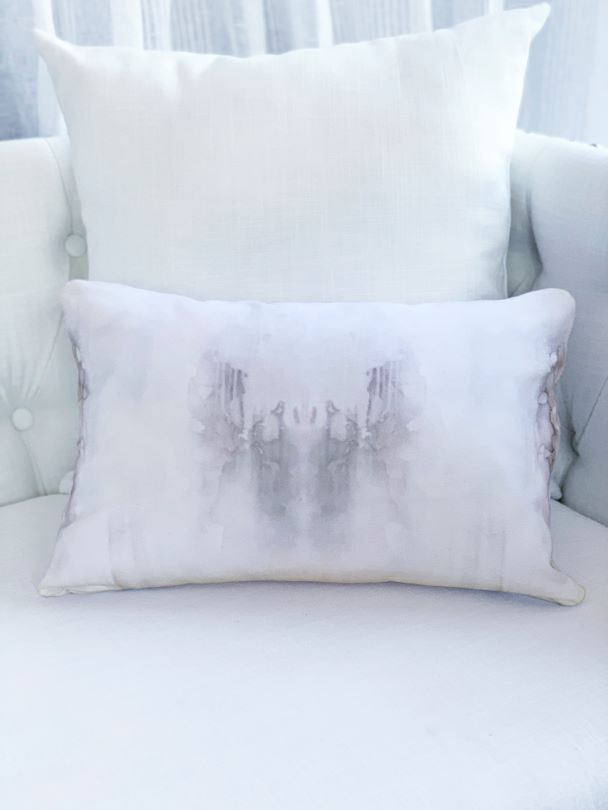 Grey and white lumbar pillow on white sofa