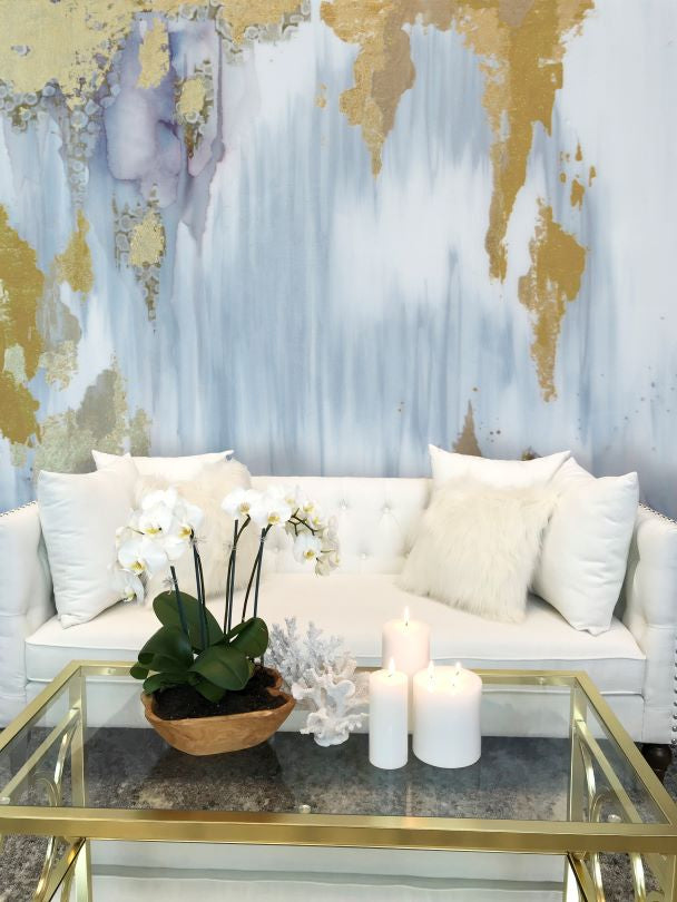 blue gray and gold large wall mural behind white sofa