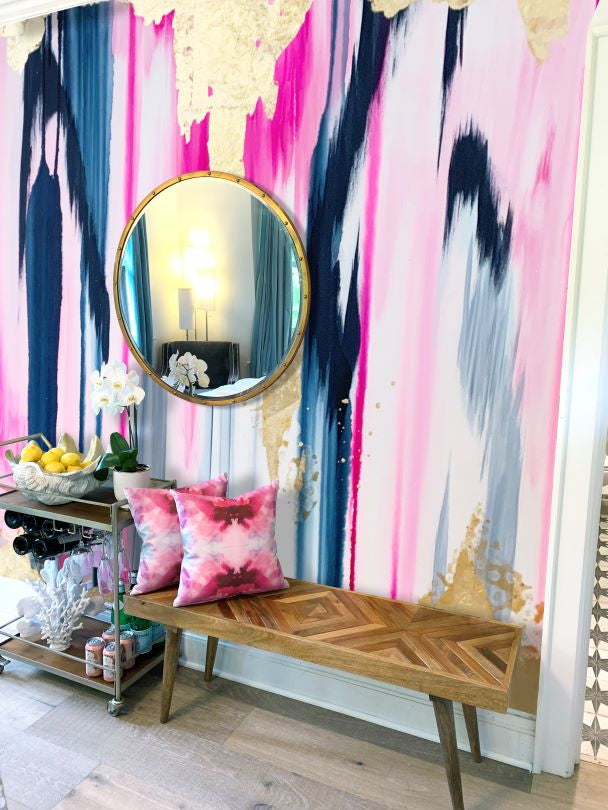 fuchsia pillow set on a wood bench